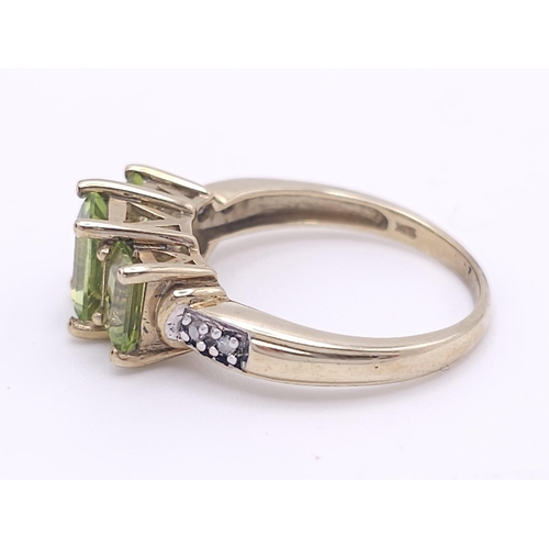 185 - A 9K GOLD PERIDOT AND DIAMOND RING .  3.1gms   size N