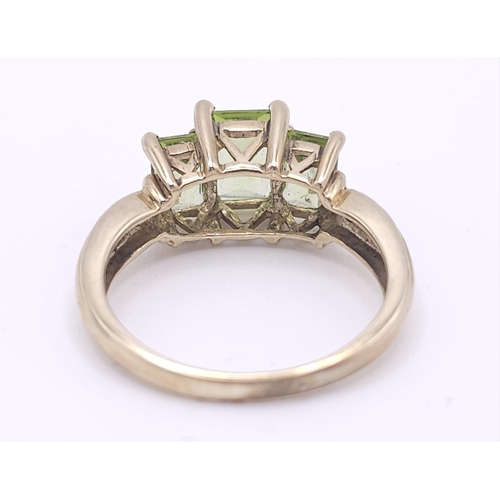 185 - A 9K GOLD PERIDOT AND DIAMOND RING .  3.1gms   size N