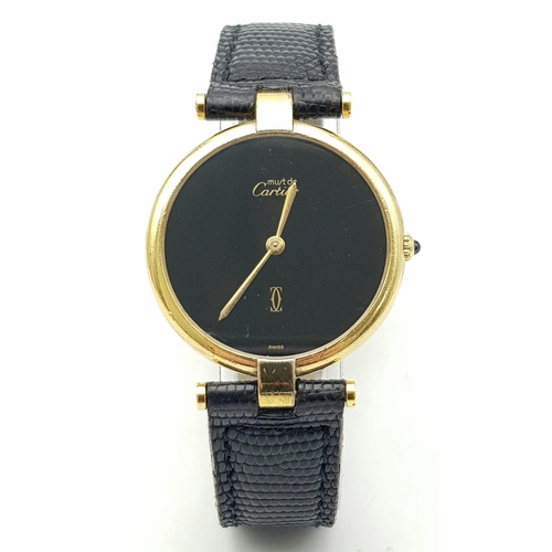 193 - A Vintage (1980s) Must de Cartier Gold Plated Quartz Ladies Watch. Black leather strap. Gold plated ... 