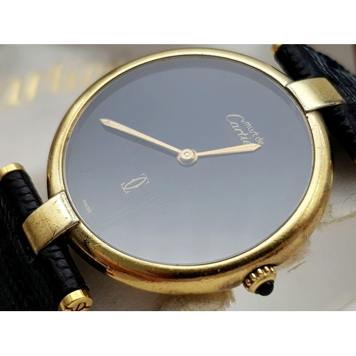 193 - A Vintage (1980s) Must de Cartier Gold Plated Quartz Ladies Watch. Black leather strap. Gold plated ... 