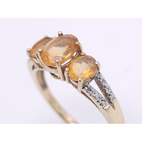 232 - A 10K GOLD CITRINE AND DIAMOND RING .  2.4gms   size N