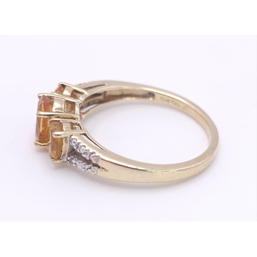 232 - A 10K GOLD CITRINE AND DIAMOND RING .  2.4gms   size N