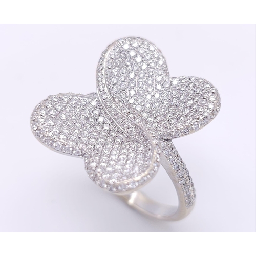 241 - A show stopping 18 K white gold ring with a large pave diamond butterfly top, size: P, weight: 8 g