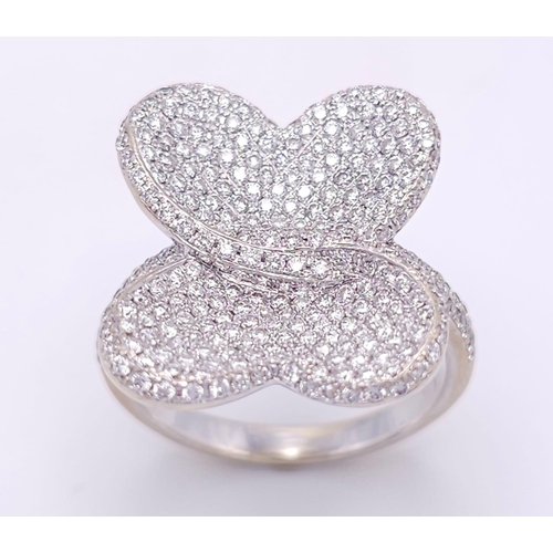 241 - A show stopping 18 K white gold ring with a large pave diamond butterfly top, size: P, weight: 8 g