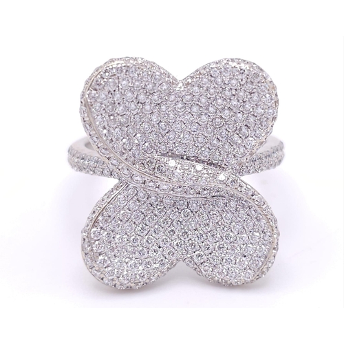 241 - A show stopping 18 K white gold ring with a large pave diamond butterfly top, size: P, weight: 8 g