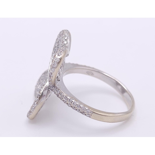 241 - A show stopping 18 K white gold ring with a large pave diamond butterfly top, size: P, weight: 8 g