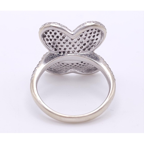 241 - A show stopping 18 K white gold ring with a large pave diamond butterfly top, size: P, weight: 8 g