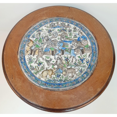 29 - AN ANTIQUE SMALL QAJAR TABLE WITH CERAMIC TOP DEPICTING THE PERSIAN VICTORIES IN BATTLE .  51cms TAL... 