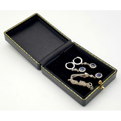 295 - An 18K White Gold, Diamond and Sapphire Jewellery Set. Oval cut sapphire with diamond surround on an... 