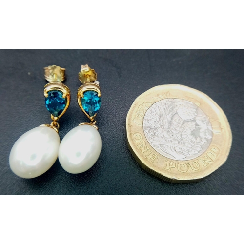 309 - A Pair of White Pearl and London Blue Topaz 9K Gold Drop Earrings. 3.6g total weight.