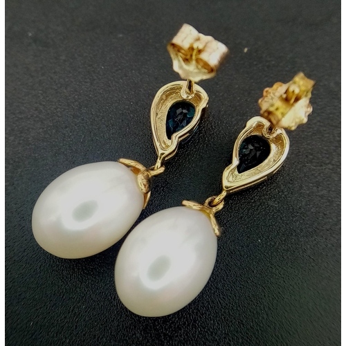 309 - A Pair of White Pearl and London Blue Topaz 9K Gold Drop Earrings. 3.6g total weight.