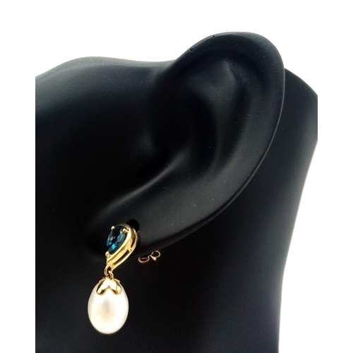 309 - A Pair of White Pearl and London Blue Topaz 9K Gold Drop Earrings. 3.6g total weight.