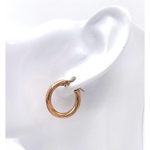 463 - A PAIR OF 9K GOLD TWIST HOOP EARRINGS .  1.2gms