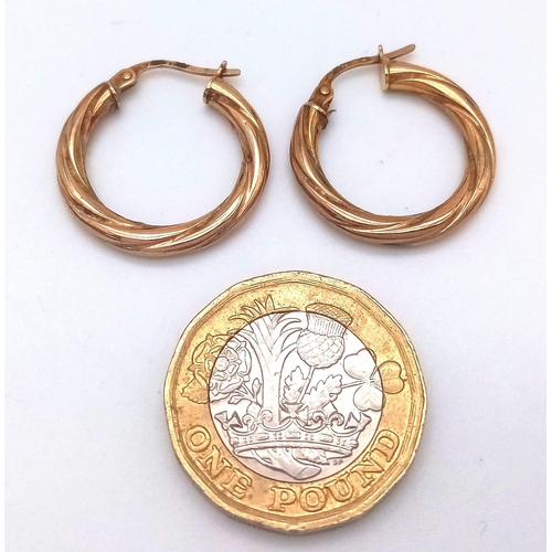 463 - A PAIR OF 9K GOLD TWIST HOOP EARRINGS .  1.2gms