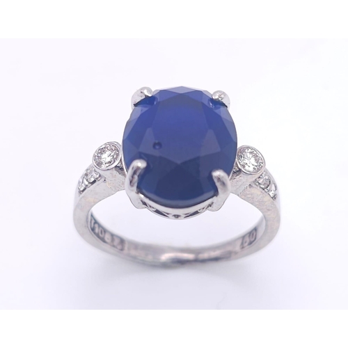 72 - An 18K White Gold Sapphire and Diamond Ring. Central 3ct sapphire with diamond accents. Size M. 4.95... 