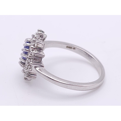 75 - A STUNNING 18K WHITE GOLD DIAMOND & TANZANITE CLUSTER RING, WITH APPROX 0.40CT TANZANITE CENTRE AND ... 