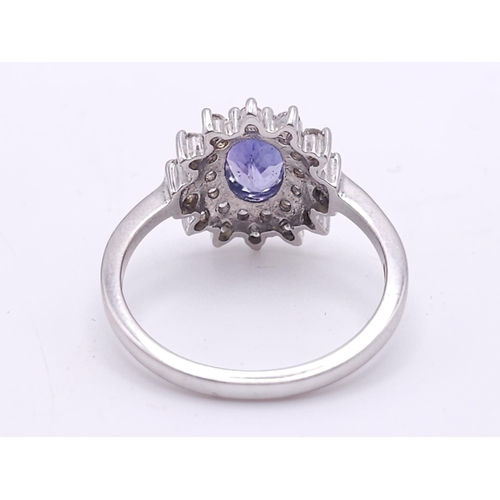 75 - A STUNNING 18K WHITE GOLD DIAMOND & TANZANITE CLUSTER RING, WITH APPROX 0.40CT TANZANITE CENTRE AND ... 