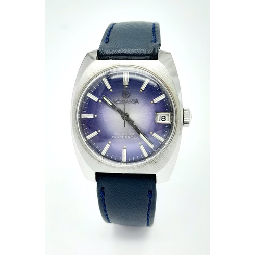 1276 - A Vintage Rodania Mechanical Gents Watch. Blue leather strap. Stainless steel case - 32mm. Purple di... 