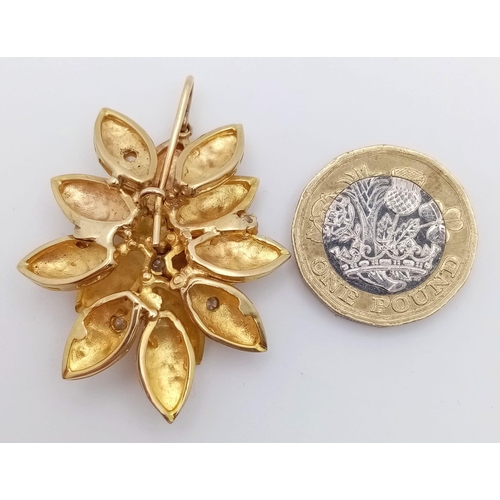 1195 - A 9K Yellow Gold (tested) and Diamond Decorative Floral Brooch. Six brilliant white zircons amongst ... 