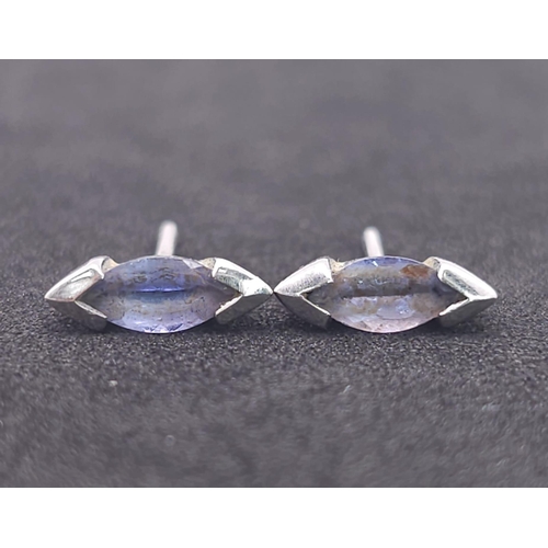 1215 - A Pair of 9K White Gold (tested) and Tanzanite Earrings. No backs. 1.1g total weight.