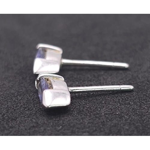 1215 - A Pair of 9K White Gold (tested) and Tanzanite Earrings. No backs. 1.1g total weight.