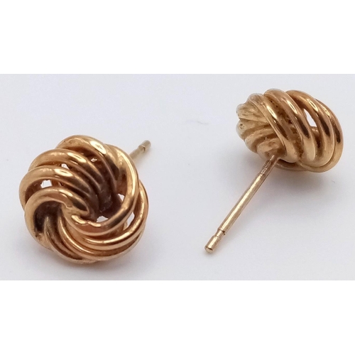 1061 - A Pair of 9K Yellow Gold Knot Stud Earrings. No backs. 0.82g weight.