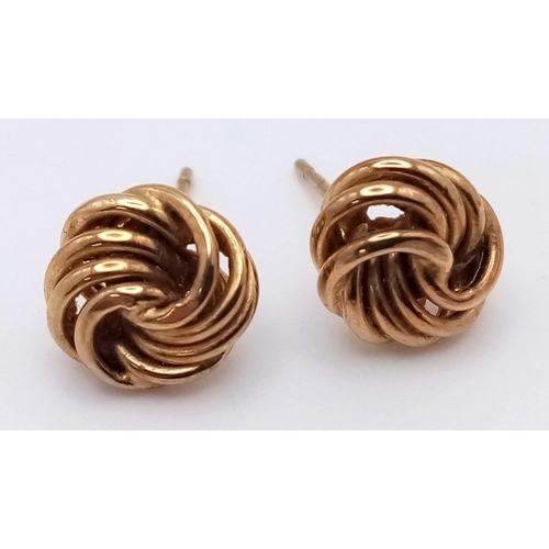 1061 - A Pair of 9K Yellow Gold Knot Stud Earrings. No backs. 0.82g weight.