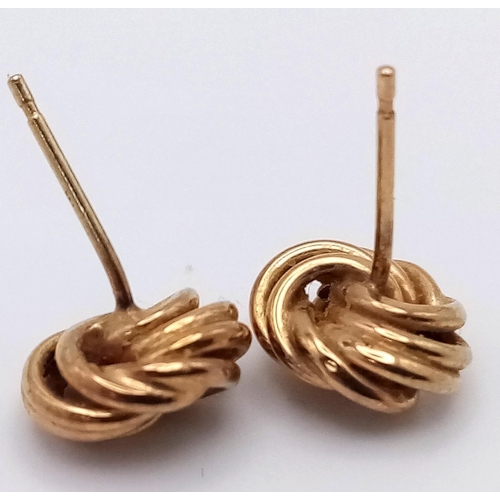 1061 - A Pair of 9K Yellow Gold Knot Stud Earrings. No backs. 0.82g weight.