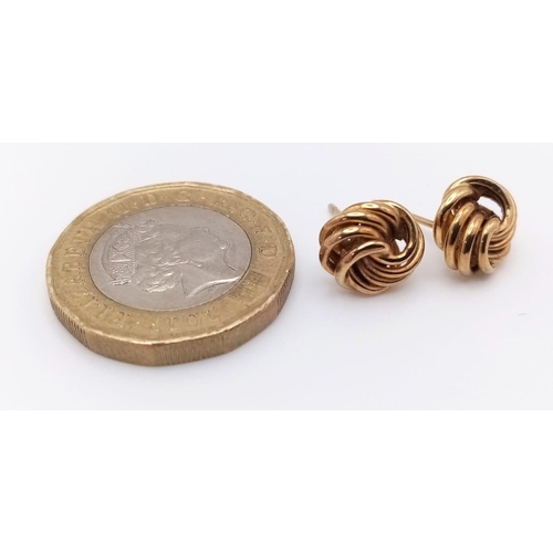 1061 - A Pair of 9K Yellow Gold Knot Stud Earrings. No backs. 0.82g weight.