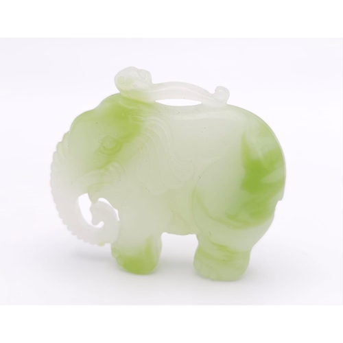 1047 - A Chinese Green and White Jade Elephant Figurine Pendant. 
5cm x 4cm.