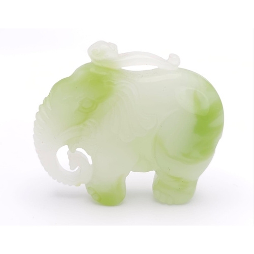 1047 - A Chinese Green and White Jade Elephant Figurine Pendant. 
5cm x 4cm.