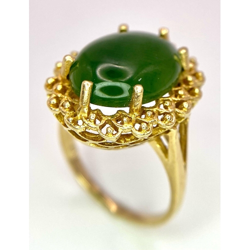 121 - A Fine Oval Cut Green Jade Ring set in 14K gold. 
Size P. 5.83g total weight. Ref: T1R