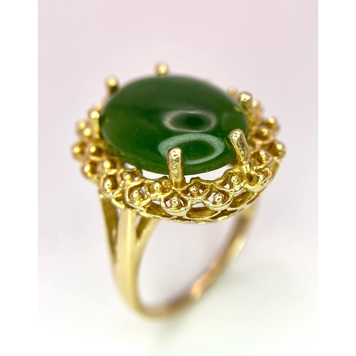 121 - A Fine Oval Cut Green Jade Ring set in 14K gold. 
Size P. 5.83g total weight. Ref: T1R