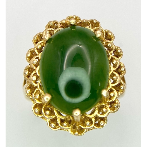 121 - A Fine Oval Cut Green Jade Ring set in 14K gold. 
Size P. 5.83g total weight. Ref: T1R