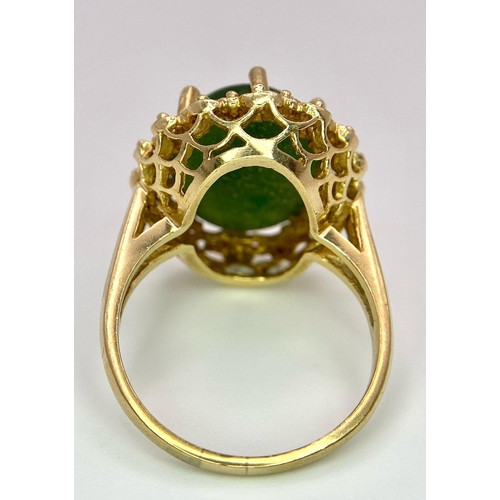 121 - A Fine Oval Cut Green Jade Ring set in 14K gold. 
Size P. 5.83g total weight. Ref: T1R