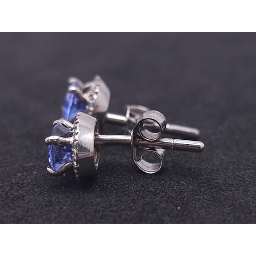 127 - A Stunning Pair of White Gold, Tanzanite and Diamond Stud Earrings. 2.3g total weight