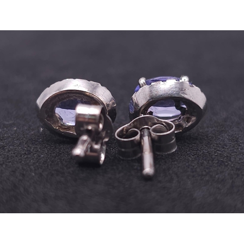 127 - A Stunning Pair of White Gold, Tanzanite and Diamond Stud Earrings. 2.3g total weight