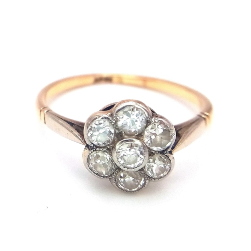 15 - A Vintage 18K Yellow Gold Diamond Ring. Seven round cut diamonds in a floral shape. Size P. 2.52g to... 