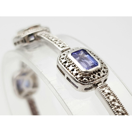 267 - An Exquisite Sterling Silver and Eight Rectangle Cut Tanzanite Set Bracelet. Complete with original ... 