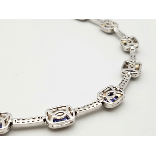 267 - An Exquisite Sterling Silver and Eight Rectangle Cut Tanzanite Set Bracelet. Complete with original ... 