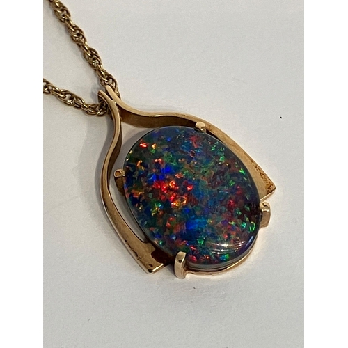 406 - Stunning 9 carat GOLD, OPAL SET PENDANT and CHAIN. Having a large oval black fire lab OPAL in a  9 c... 