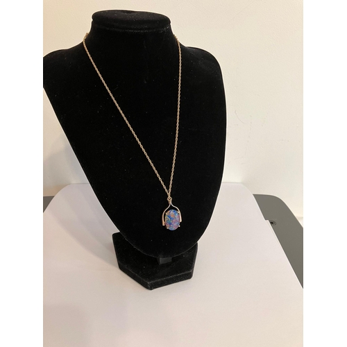 406 - Stunning 9 carat GOLD, OPAL SET PENDANT and CHAIN. Having a large oval black fire lab OPAL in a  9 c... 