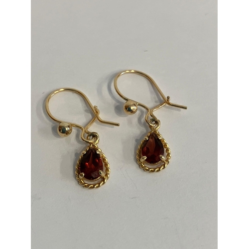 448 - 9 carat GOLD and GARNET EARRINGS. Having Pear cut Garnets with GOLD rope twist surround in Drop styl... 