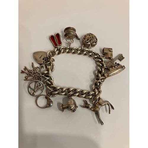 518 - Vintage SILVER CHARM BRACELET, mounted with a selection of SILVER charms to include a Fawn with gems... 