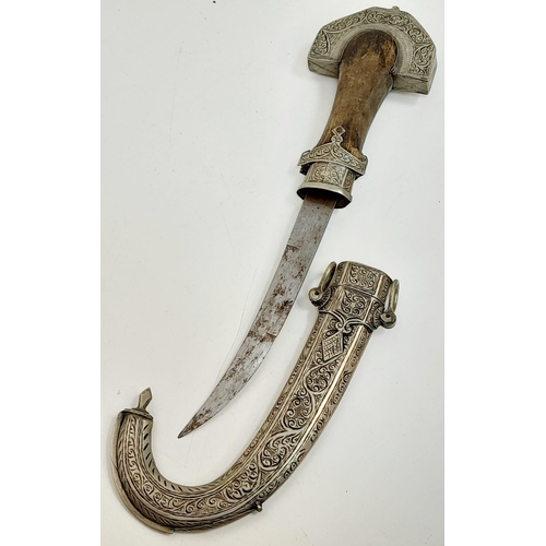 597 - An antique, very ornamental, white metal (untested) possibly Indian, ceremonial,  curved dagger with... 