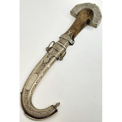 597 - An antique, very ornamental, white metal (untested) possibly Indian, ceremonial,  curved dagger with... 