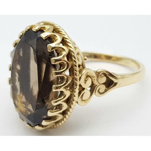 8 - A Vintage 9K Yellow Gold Smoky Quartz Ring. Large oval cut 10ct smoky quartz in a decorative setting... 