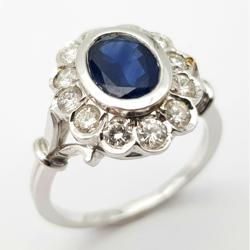 82 - A STUNNING 18K WHITE GOLD DIAMOND & SAPPHIRE CLUSTER RING, WITH APPROX 0.50CT DARK BLUE SAPPHIRE CEN... 