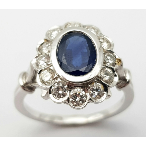 82 - A STUNNING 18K WHITE GOLD DIAMOND & SAPPHIRE CLUSTER RING, WITH APPROX 0.50CT DARK BLUE SAPPHIRE CEN... 