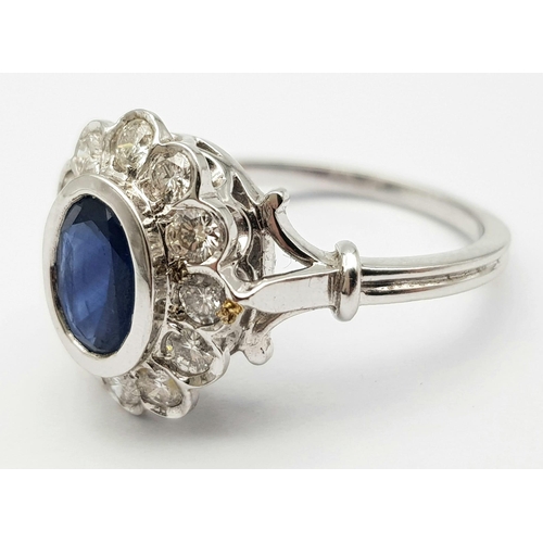 82 - A STUNNING 18K WHITE GOLD DIAMOND & SAPPHIRE CLUSTER RING, WITH APPROX 0.50CT DARK BLUE SAPPHIRE CEN... 